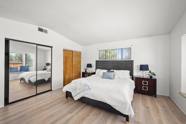 2125 Prospect St, National City, CA 91950 - bedroom featuring two closets, light wood-style floors, multiple windows, lofted ceiling, and baseboards