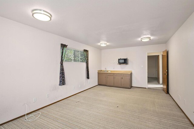 2125 Prospect St, National City, CA 91950 - unfurnished room with a sink, light colored carpet, and baseboards
