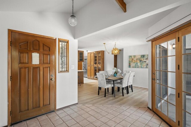 2125 Prospect St, National City, CA 91950 - entryway with lofted ceiling, a chandelier, light tile patterned floors, and baseboards