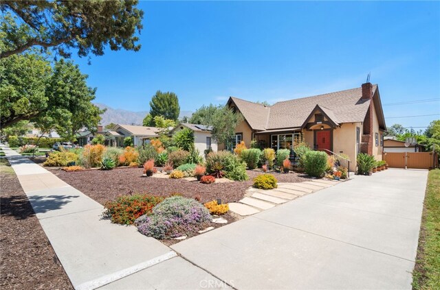 1260 Sinaloa Ave, Pasadena, CA 91104 - view of front of property with a gate, stucco siding, a chimney, a mountain view, and driveway