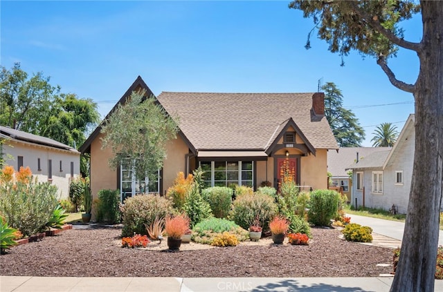 1260 Sinaloa Ave, Pasadena, CA 91104 - tudor house with stucco siding, roof with shingles, and a chimney