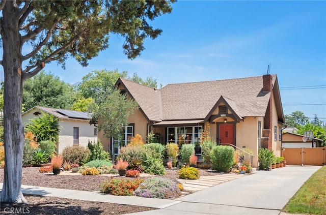 1260 Sinaloa Ave, Pasadena, CA 91104 - view of front of home featuring stucco siding, a gate, roof with shingles, concrete driveway, and a chimney