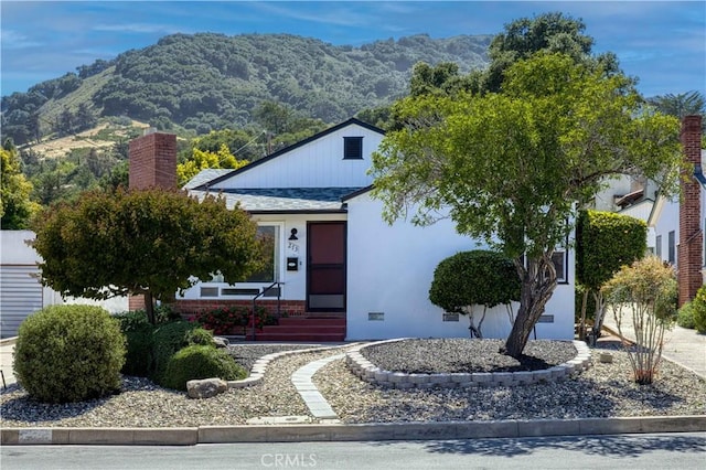 273 Almond St, San Luis Obispo, CA 93405 - view of front of house featuring a mountain view, a chimney, entry steps, and stucco siding
