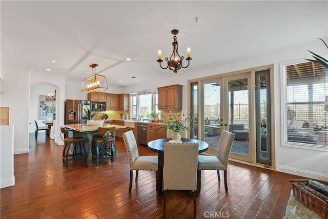 112 Del Cabo, San Clemente, CA 92673 - dining area with a chandelier, arched walkways, dark wood-style floors, baseboards, and recessed lighting