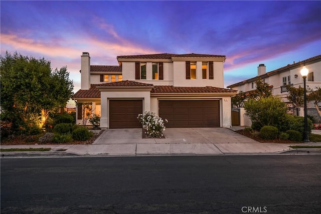 112 Del Cabo, San Clemente, CA 92673 - mediterranean / spanish home with a chimney, concrete driveway, stucco siding, an attached garage, and a tile roof
