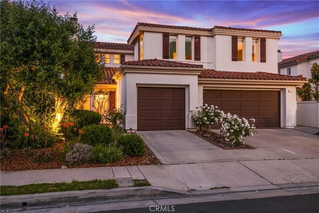 112 Del Cabo, San Clemente, CA 92673 - view of front of house with an attached garage, concrete driveway, stucco siding, and a tiled roof