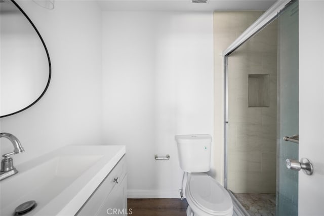 1377 Wheaton Way, Riverside, CA 92507 - bathroom with vanity, toilet, a stall shower, baseboards, and wood finished floors