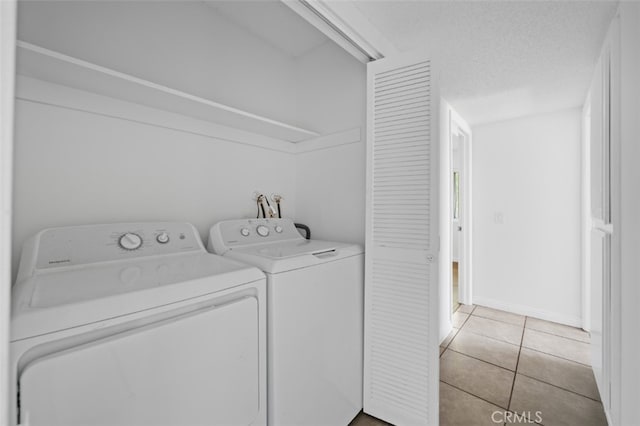 1377 Wheaton Way, Riverside, CA 92507 - washroom featuring washer and dryer, light tile patterned floors, baseboards, and a textured ceiling