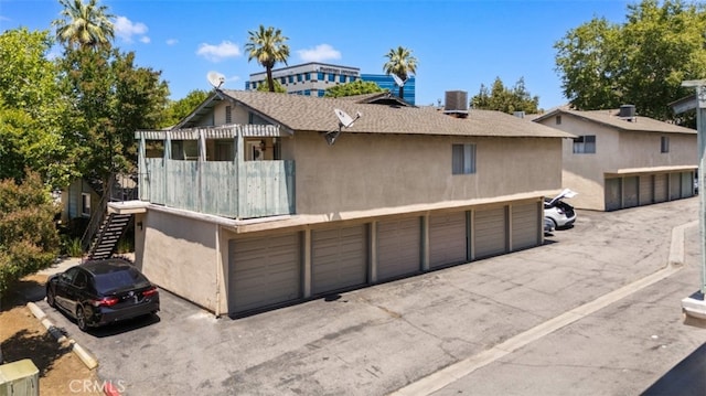1377 Wheaton Way, Riverside, CA 92507 - view of front of property featuring stairway, central AC, stucco siding, and community garages