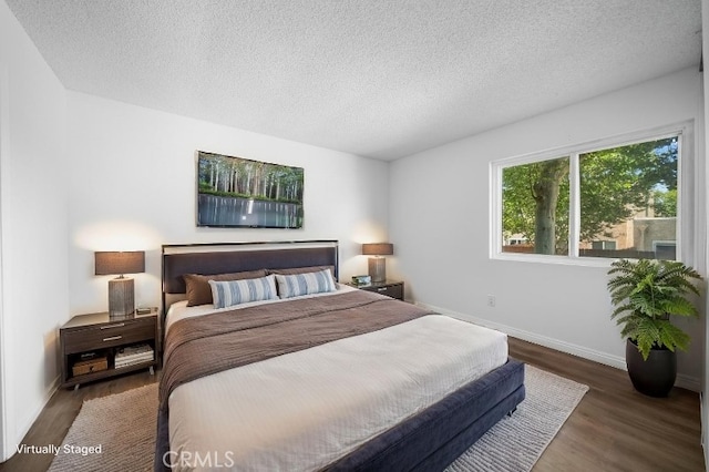 1377 Wheaton Way, Riverside, CA 92507 - bedroom featuring a textured ceiling, wood finished floors, and baseboards