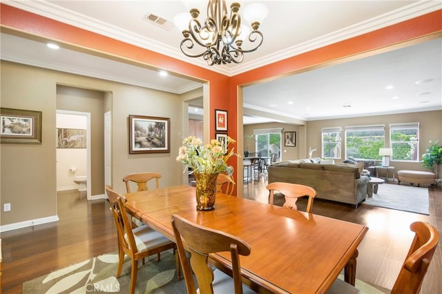 7151 Stockton Dr, Eastvale, CA 92880 - dining space featuring wood finished floors, a chandelier, ornamental molding, baseboards, and recessed lighting