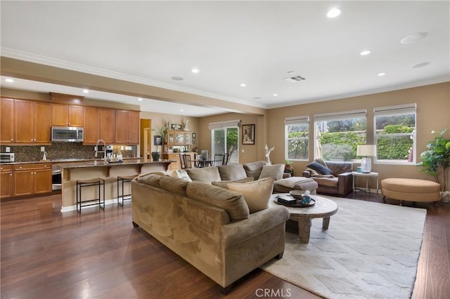 7151 Stockton Dr, Eastvale, CA 92880 - living room with dark wood-style floors, crown molding, and recessed lighting