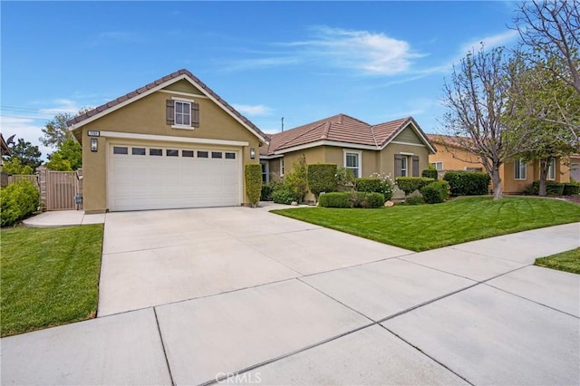 7151 Stockton Dr, Eastvale, CA 92880 - view of front of home featuring a garage, stucco siding, a tile roof, concrete driveway, and a gate