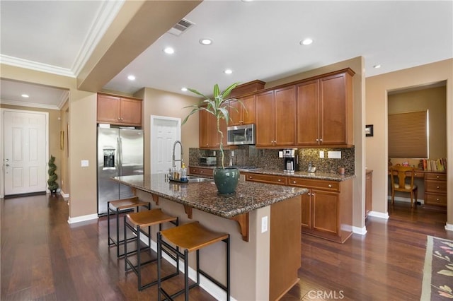 7151 Stockton Dr, Eastvale, CA 92880 - kitchen with appliances with stainless steel finishes, a sink, crown molding, a kitchen breakfast bar, and tasteful backsplash