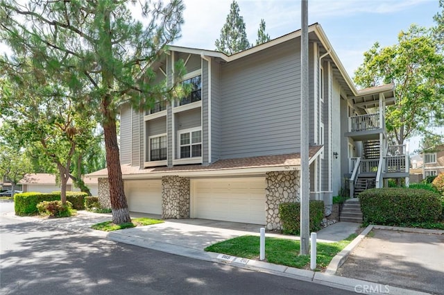 565 Ophir Cir, San Dimas, CA 91773 - multi unit property featuring stairs, stone siding, an attached garage, and concrete driveway
