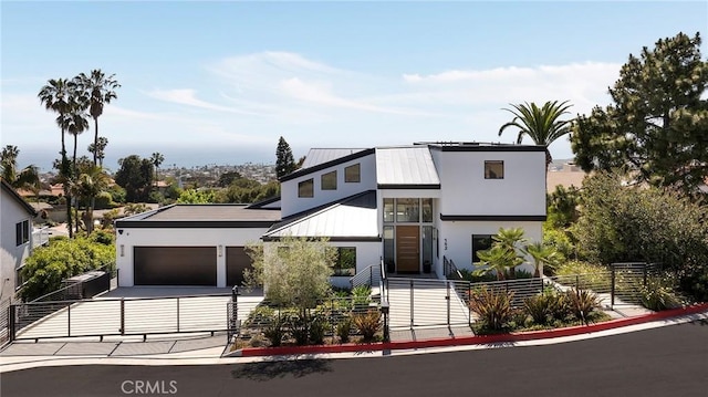152 El Levante, San Clemente, CA 92672 - modern home featuring a fenced front yard, a garage, concrete driveway, metal roof, and stucco siding