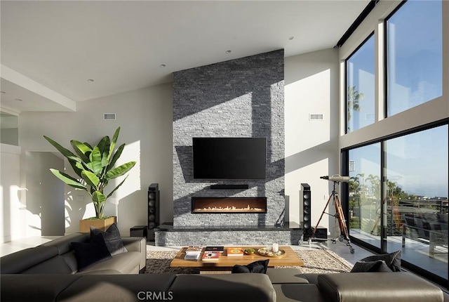 152 El Levante, San Clemente, CA 92672 - living area with healthy amount of natural light, a stone fireplace, and a towering ceiling