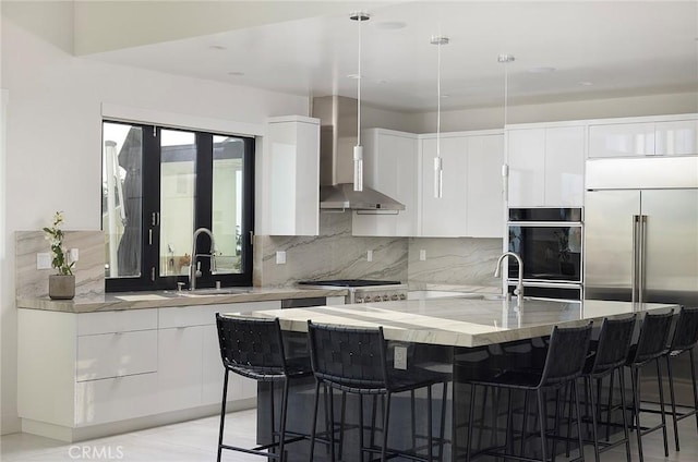 152 El Levante, San Clemente, CA 92672 - kitchen with wall chimney exhaust hood, a sink, white cabinets, and tasteful backsplash