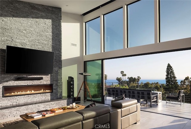 152 El Levante, San Clemente, CA 92672 - tiled living area featuring a fireplace, a towering ceiling, and plenty of natural light