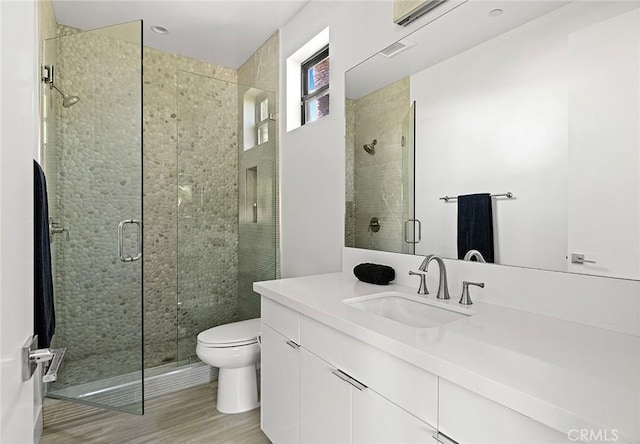 152 El Levante, San Clemente, CA 92672 - bathroom with toilet, a stall shower, vanity, and wood finished floors