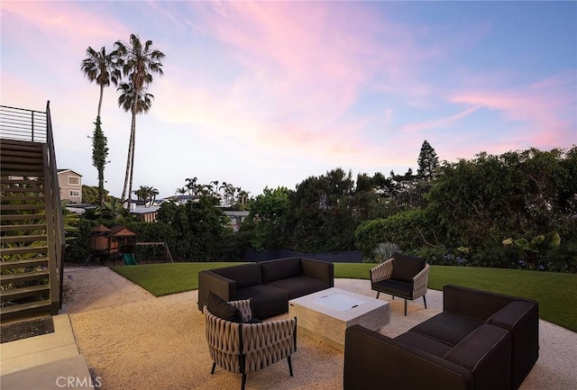 152 El Levante, San Clemente, CA 92672 - patio terrace at dusk with an outdoor living space, a playground, a patio, a lawn, and stairway