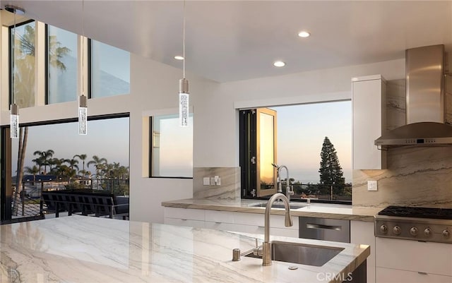152 El Levante, San Clemente, CA 92672 - kitchen featuring wall chimney range hood, appliances with stainless steel finishes, modern cabinets, a sink, and white cabinetry