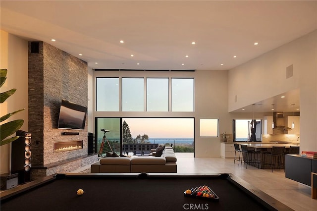 152 El Levante, San Clemente, CA 92672 - playroom with pool table, a towering ceiling, a fireplace, and recessed lighting