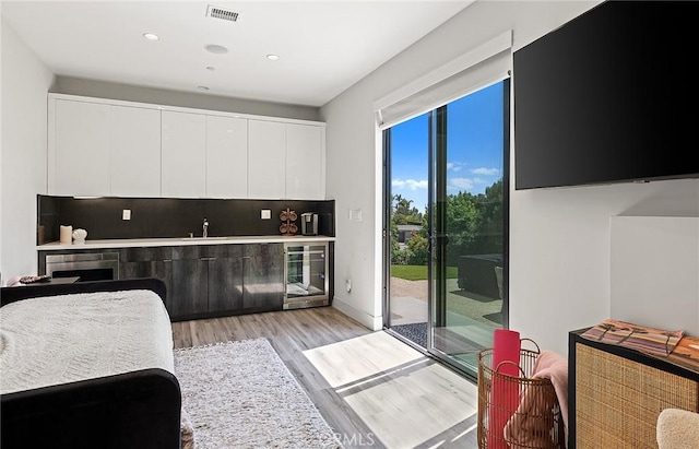 152 El Levante, San Clemente, CA 92672 - bedroom featuring beverage cooler, access to outside, light wood finished floors, a dry bar, and recessed lighting