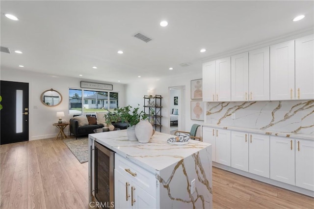 212 Oak Pl, Brea, CA 92821 - kitchen with beverage cooler, light wood-style flooring, a kitchen island, white cabinetry, and recessed lighting