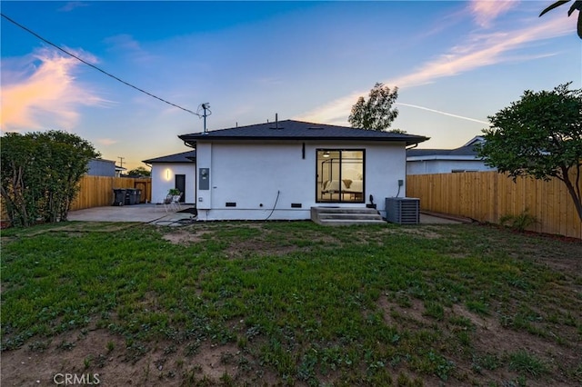 212 Oak Pl, Brea, CA 92821 - back of property at dusk with stucco siding, a patio, central AC unit, and entry steps