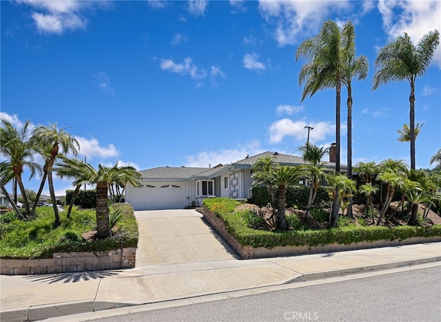 2620 W Cobblestone Rd, La Habra, CA 90631 - view of front of property with a garage, concrete driveway, and a chimney