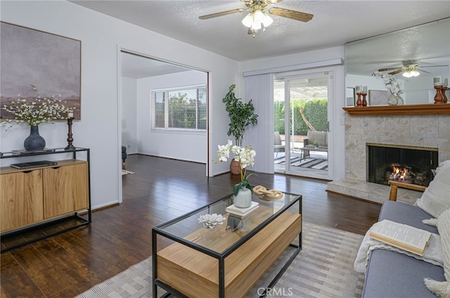 2620 W Cobblestone Rd, La Habra, CA 90631 - living room with ceiling fan, wood finished floors, a fireplace, a textured ceiling, and baseboards