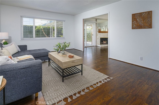 2620 W Cobblestone Rd, La Habra, CA 90631 - living room featuring hardwood / wood-style flooring, baseboards, and a warm lit fireplace
