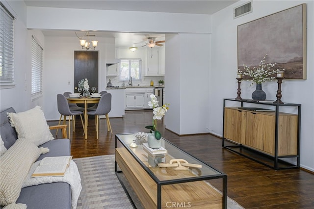 2620 W Cobblestone Rd, La Habra, CA 90631 - living room with dark wood-style floors, a ceiling fan, and a chandelier