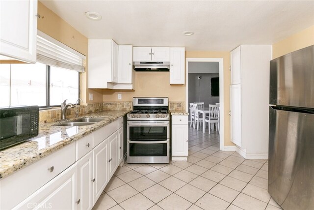 38633 Angele Trumpet Ct, Palmdale, CA 93550 - kitchen with appliances with stainless steel finishes, a sink, under cabinet range hood, and white cabinets
