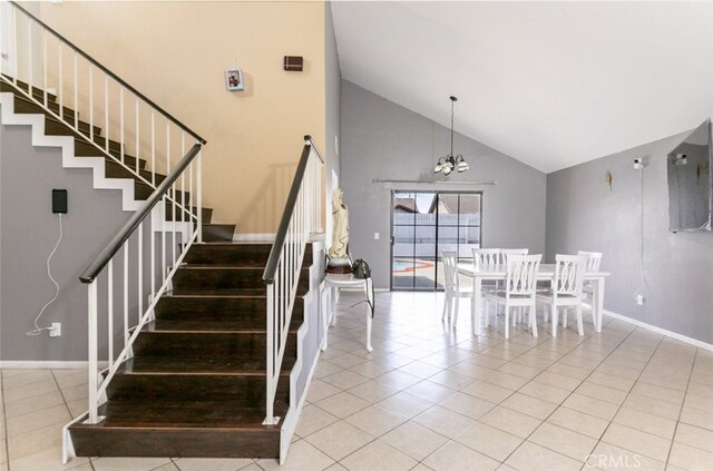 38633 Angele Trumpet Ct, Palmdale, CA 93550 - stairway with tile patterned flooring, high vaulted ceiling, a chandelier, and baseboards