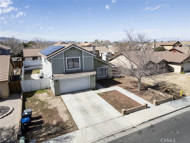 38633 Angele Trumpet Ct, Palmdale, CA 93550 - traditional home with solar panels, a garage, driveway, and a residential view