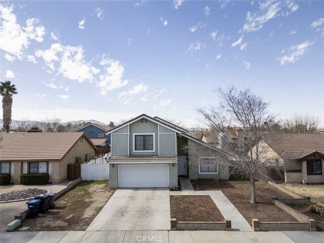 38633 Angele Trumpet Ct, Palmdale, CA 93550 - view of front of property with an attached garage, concrete driveway, and stucco siding