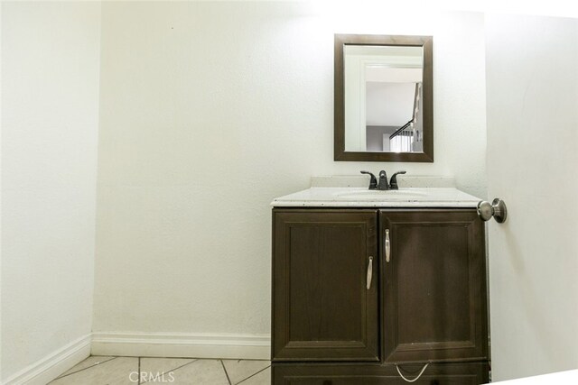 38633 Angele Trumpet Ct, Palmdale, CA 93550 - bathroom with baseboards, vanity, and tile patterned flooring