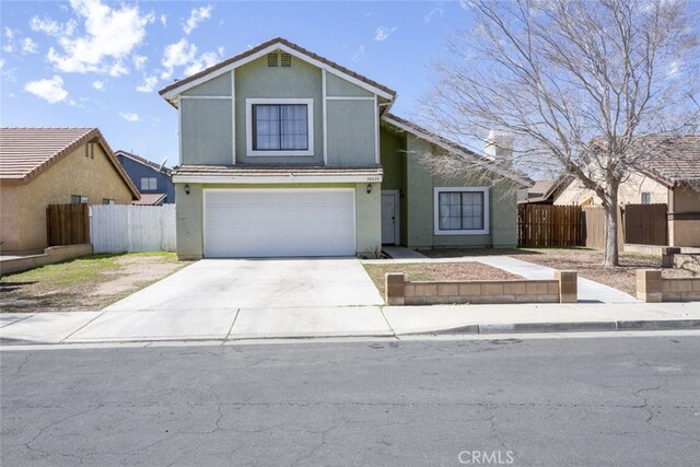 38633 Angele Trumpet Ct, Palmdale, CA 93550 - view of front facade with stucco siding, an attached garage, and concrete driveway