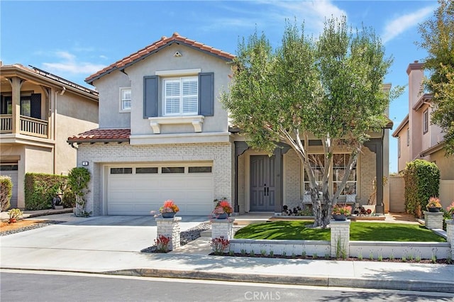 4 Sunswept Mesa, Aliso Viejo, CA 92656 - mediterranean / spanish-style home with a tiled roof, brick siding, concrete driveway, a garage, and stucco siding