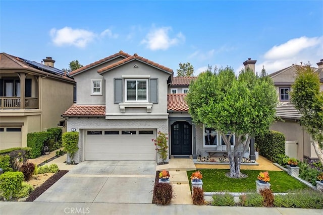 4 Sunswept Mesa, Aliso Viejo, CA 92656 - view of front of home featuring an attached garage, a tile roof, concrete driveway, stucco siding, and brick siding