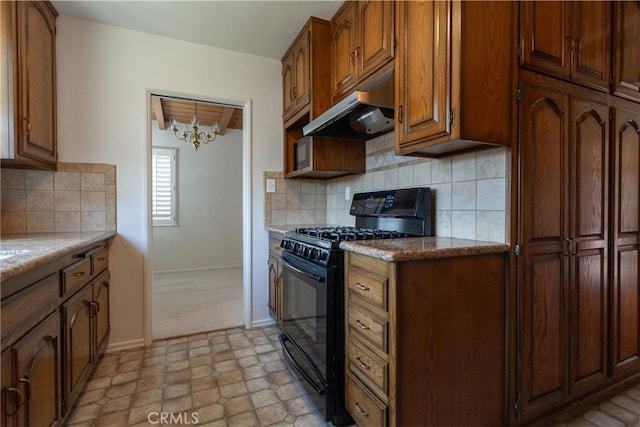 1991 Heather Dr, Monterey Park, CA 91755 - kitchen featuring gas stove, under cabinet range hood, a chandelier, brown cabinets, and tasteful backsplash