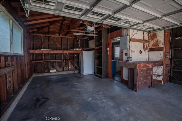 1991 Heather Dr, Monterey Park, CA 91755 - garage featuring electric panel, a workshop area, a garage door opener, and wood walls