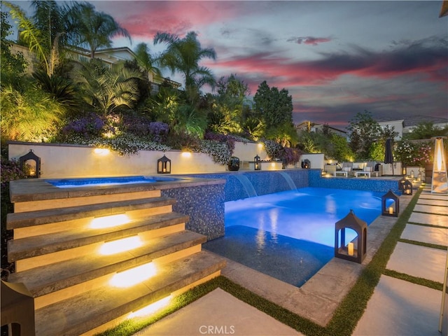 22385 Midtown Ct, Saugus, CA 91350 - pool at dusk featuring a jacuzzi and a patio area