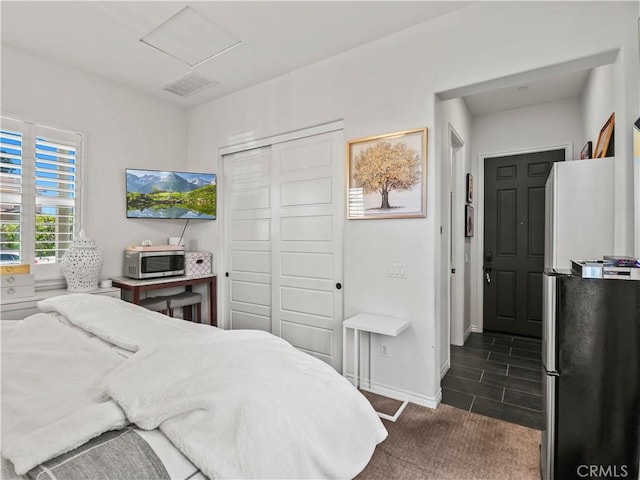 22385 Midtown Ct, Saugus, CA 91350 - bedroom with a closet, freestanding refrigerator, baseboards, and dark carpet