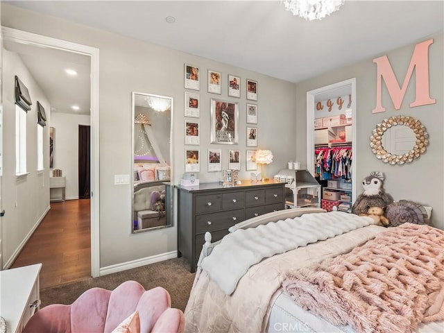 22385 Midtown Ct, Saugus, CA 91350 - bedroom with baseboards, a spacious closet, dark colored carpet, and a closet