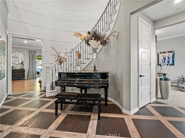 22385 Midtown Ct, Saugus, CA 91350 - foyer entrance featuring stairway, inlaid floor details, ornamental molding, baseboards, and a high ceiling
