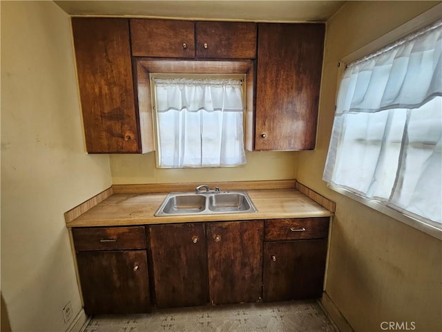 549 San Juan Ave, Venice, CA 90291 - kitchen with a sink, healthy amount of natural light, light countertops, and dark brown cabinetry