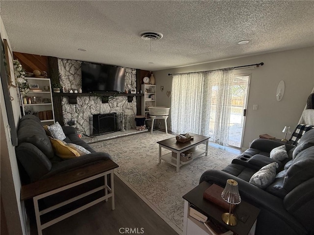 37098 San Bruno Ave, Barstow, CA 92311 - living area with a textured ceiling, wood finished floors, and a stone fireplace